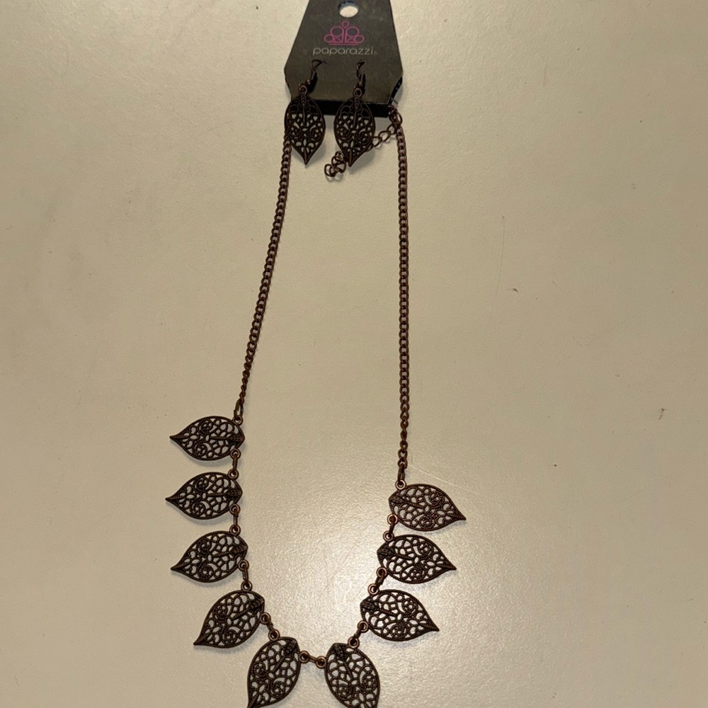 Brand new brown neck lace with leafs on it